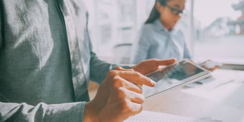 Man uses ipad to research insurance