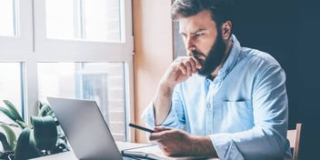 man reading over information about divorce waiting periods in his state