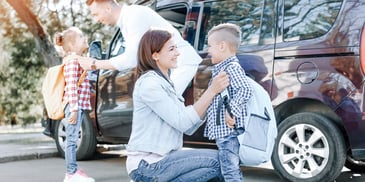 ex spouses saying goodbyes and hellos to their children as they trade off parenting time