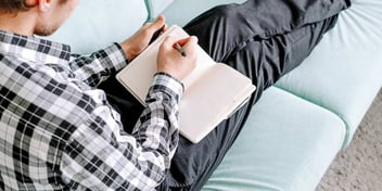 Man writes in his notebook
