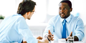 two men meeting about business matters in an office