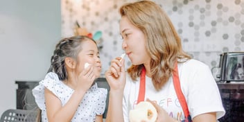 Mom and daughter eat a snack