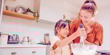 mom and daughter baking holiday cookies together