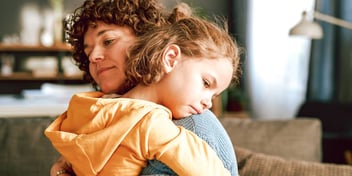 mother embracing young daughter