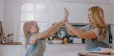 mom and daughter doing a high-five