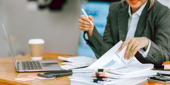 person reviewing paperwork at a desk