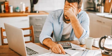 frustrated man crunching numbers