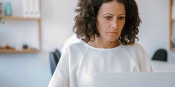 Older caucasian woman working on her laptop.
