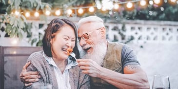 Older couple feeds each other on a date after divorce