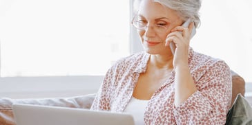 woman on the phone in front of her computer