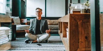 man mediating and taking a break from his work