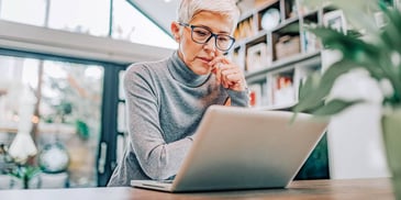 woman looking at her laptop considering her divorce options online
