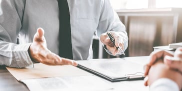 two people meeting and updating paperwork