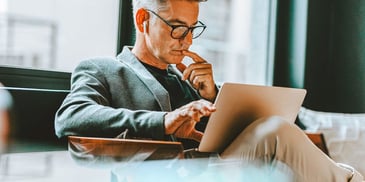pensive looking man reading online