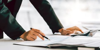 person going over documents and taking notes