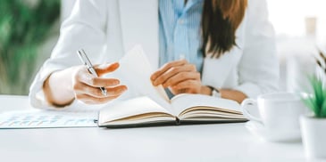 professional healthcare worker taking notes at a desk