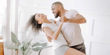 couple dancing together at home