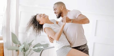 couple dancing together at home
