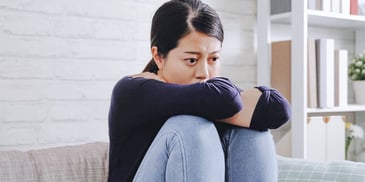 scared woman sitting alone on a porch