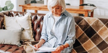 Woman looks over the documents she needs to file her QDRO