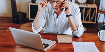 Man looks at his financial information on his laptop