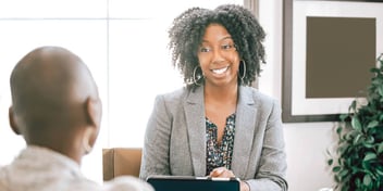 Two black women conversing in an office