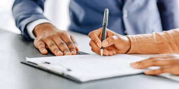 woman signing paperwork
