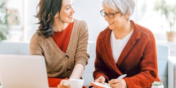 younger woman explaining something to an older woman