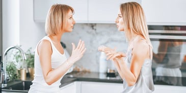 domestic partners talking in their kitchen