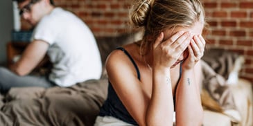 sad woman with her face in her hands