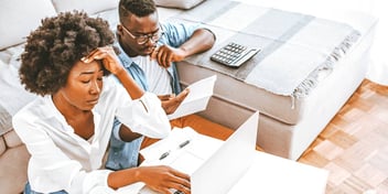 stressed out Black couple looking over their finances