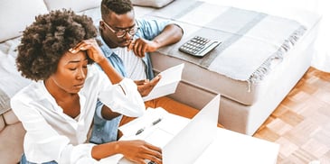 stressed out Black couple looking over their finances