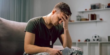 man feeling sorry for himself and looking at his phone