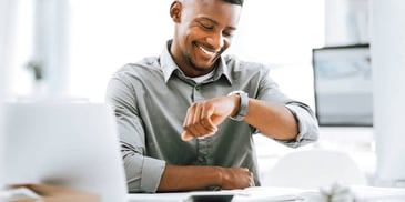 man looking at the time on his watch