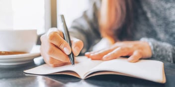 person writing a list of things they need to do before they file for divorce