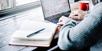 Man looks at the calendar on his laptop as he plans his divorce