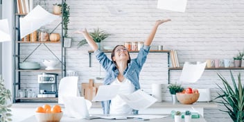 woman celebrating and relieving stress after completing paperwork