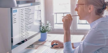 woman looking at her emails on a computer