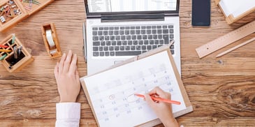 writing on paperwork and computer