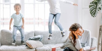 kids jump on couch and mom is tired