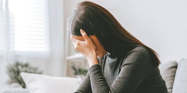 grieving woman holding her head