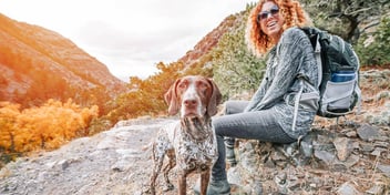 woman with her dog on a hiking trail
