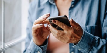 woman reviewing a checklist on her smart phone