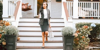 woman leaving her house with coffee on her way to a job interview