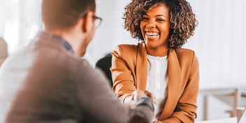 man and woman shaking hands after a good meeting