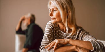 man and woman sitting far apart from each other