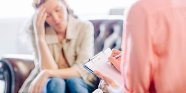 overwhelmed woman talking to her divorce coach