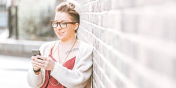 woman looking at her mobile device