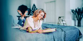 woman reading inspirational quotes in a book