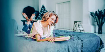 woman reading inspirational quotes in a book